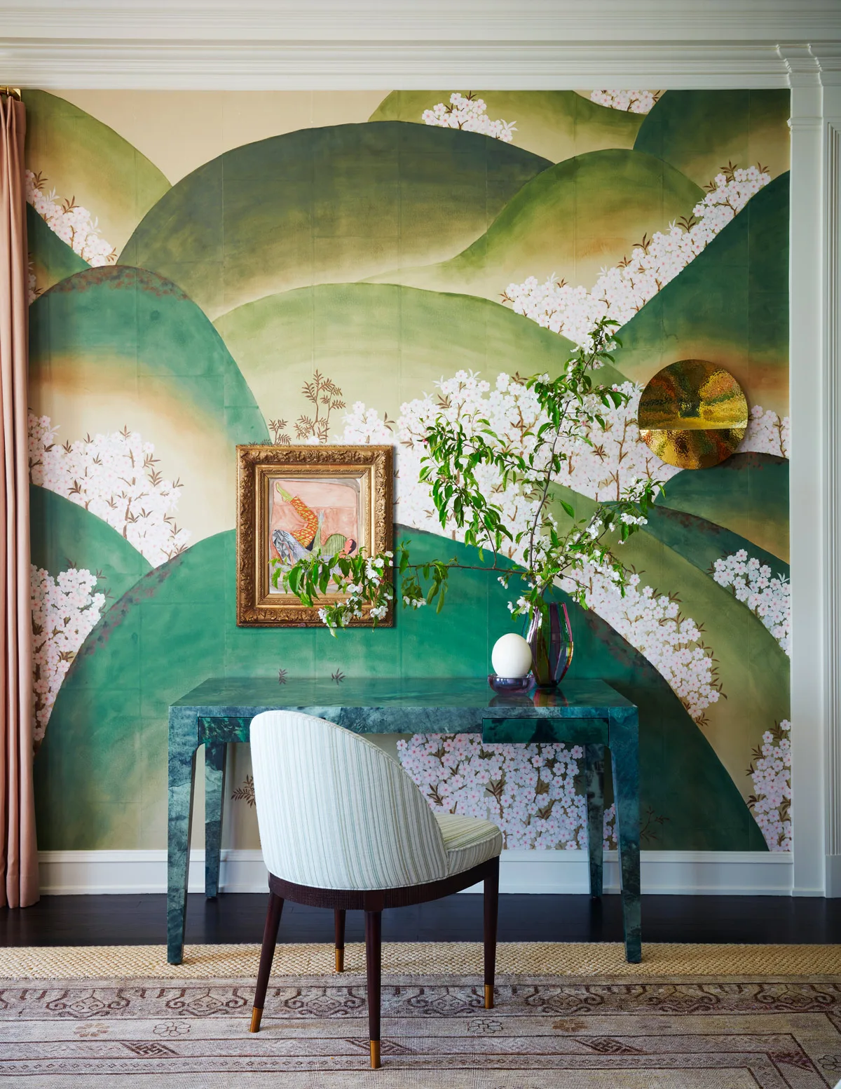 De Gournay hand-painted green mountain landscape wallpaper above a dark console